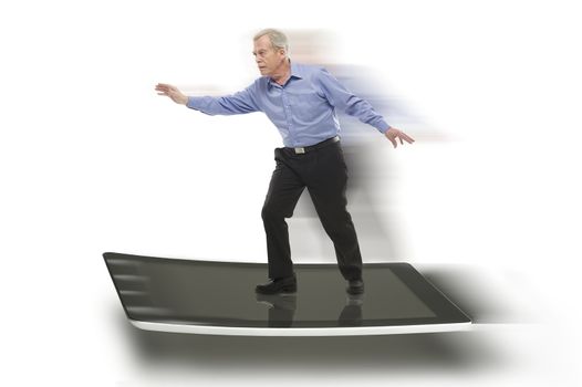 Senior businessman keeping balance on a PC tablet, with blurred motion effect