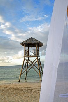 Tropical watchtower overlooking a beach wedding set up