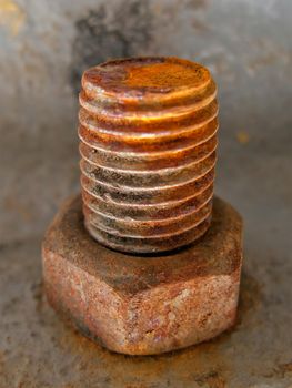 Old rusty metal nut on iron water valve pipe