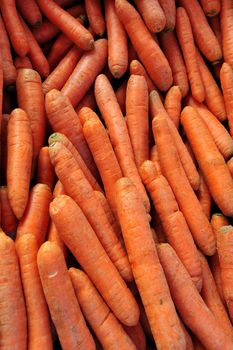 Close up of carrots on a market stall. Suitable as an organic background
