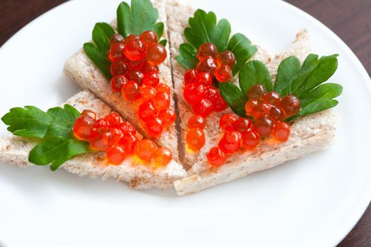 Tartlets with caviar and parsley on a plate