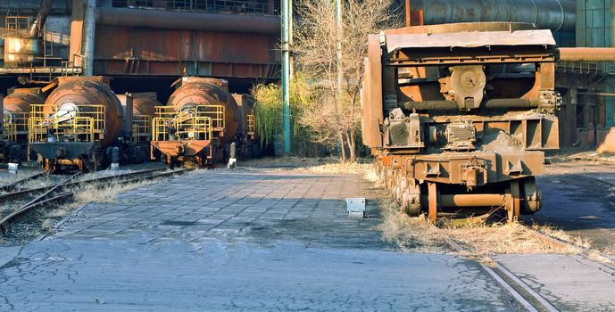 Closeup landscape photo of cargo carriages and trains in industrial factory