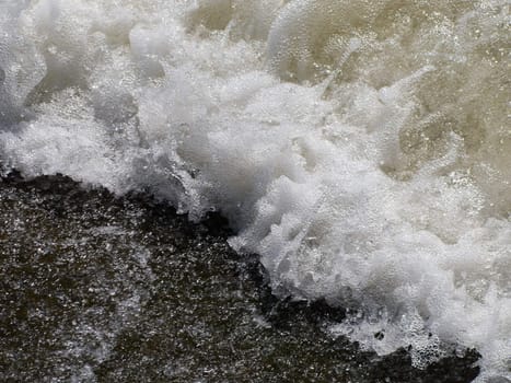 Wave of sea and water foam on beach at summer