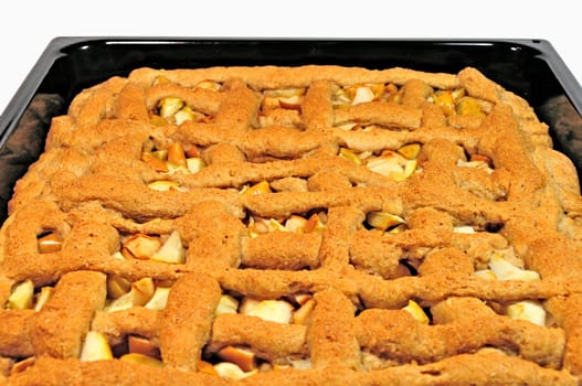 apple pie in the pan, close-up isolated