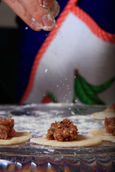 hand made ravioli getting prepared on table 