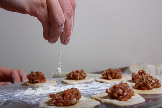 hand made ravioli getting prepared on table 