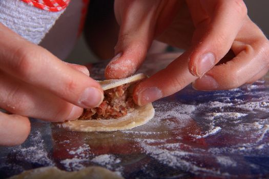 hand made ravioli getting prepared on table 