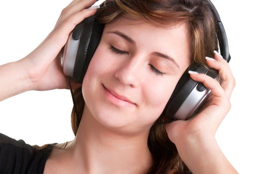 Young woman listening to music through her headphones, with her eyes closed, isolated in a white background