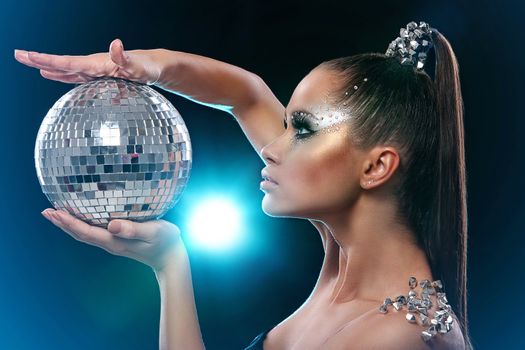 Portrait of woman with artistic make-up and rhinestones over background