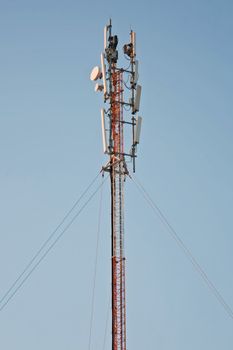 Communications antenna tower with repeater equipment