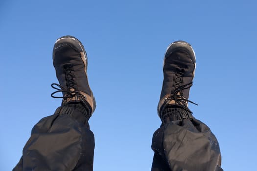 Adult human leg foot up blue winter sky outdoor