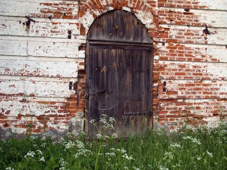 Old church closed entrance with wood door and lock