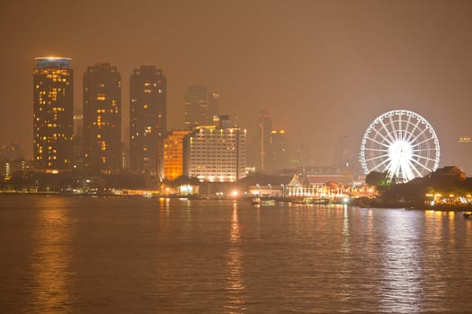 Ferris Wheel and night river in Bangkok, Thailand