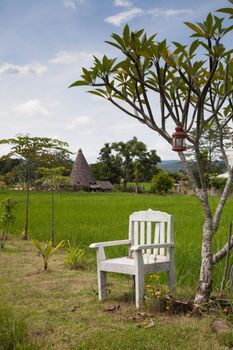 The white chairs. Located on the side of the field.