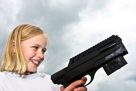 Girl playing with a gun in denmark in the summer