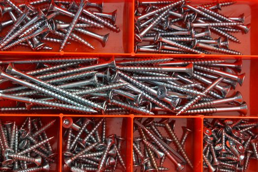 Several nails in a red box
