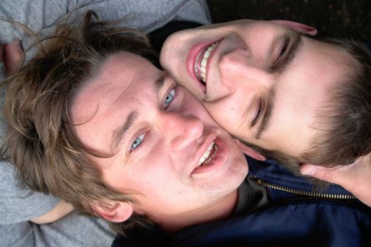 Friends. Two beautiful young men close up.