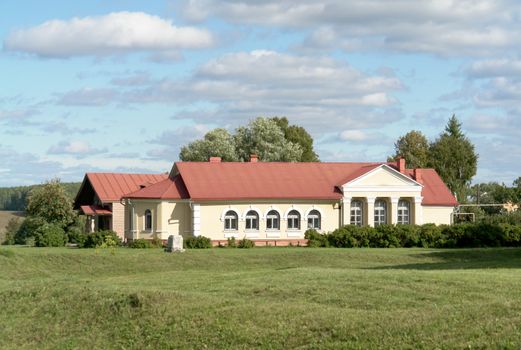 Rural landscape. The beautiful house on a green meadow.