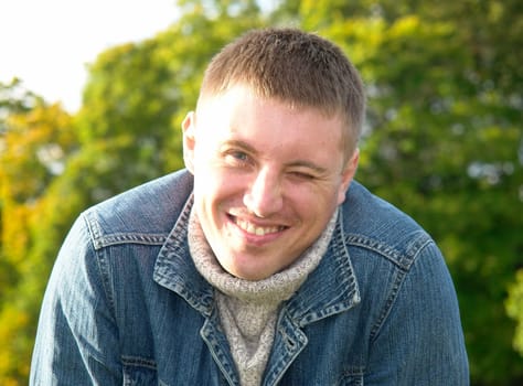Portrait of the young man in a sharp sunlight