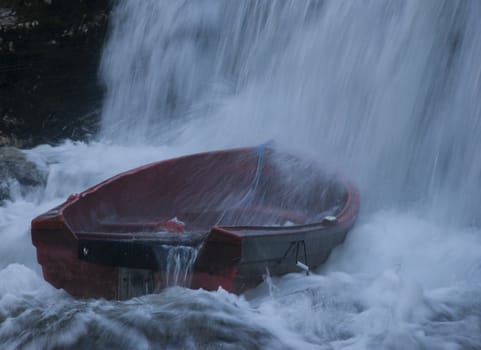 Boat in waterfall after heavy rain