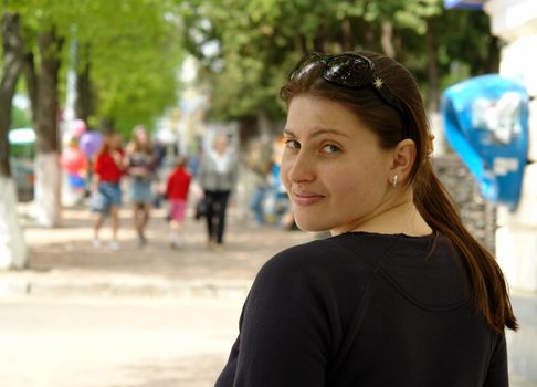 The young beautiful woman in city street