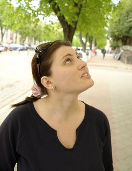The young beautiful woman in city street