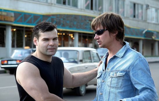 Two young men in city street