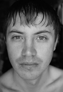 Black-and-white portrait. A man's face close up