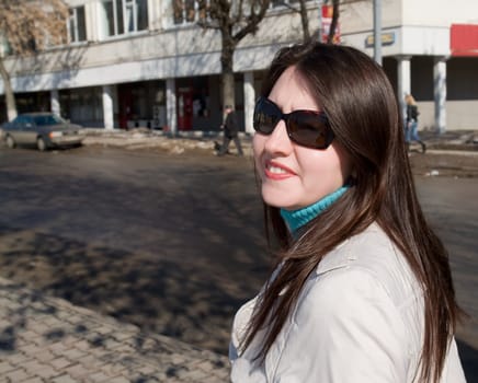 The young beautiful woman in city street