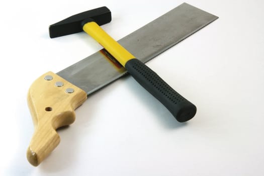 hand saw and yellow hammer on white background construction concepts
