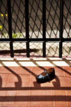 Abandoned child's shoe on balcony with diffuse filter