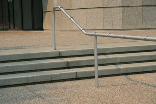 Close up of steps and handrails of an entrance.
