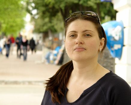 The young beautiful woman in city street