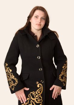 The young beautiful woman in a black coat