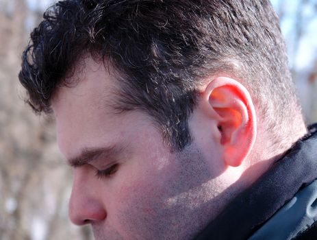 Ear. A man's face in a profile close up.