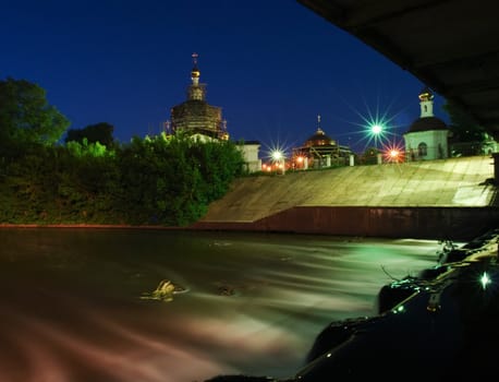 Night city landscape. The small river in lantern light.