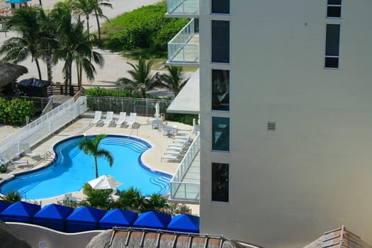 Swimming pool and lounge chairs in a hotel.
