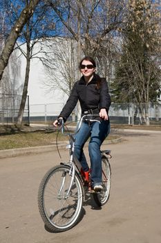 The young beautiful woman on a bicycle
