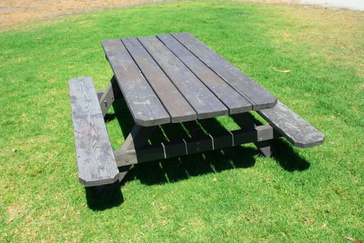 Picnic table in a park on a sunny day.
