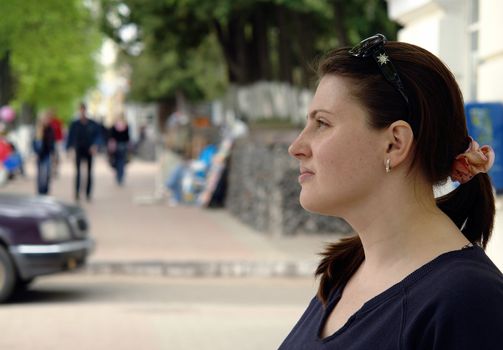 The young beautiful woman in city street