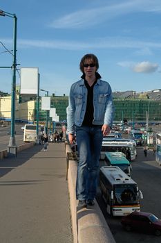 Cool dude goes on an edge of the high bridge