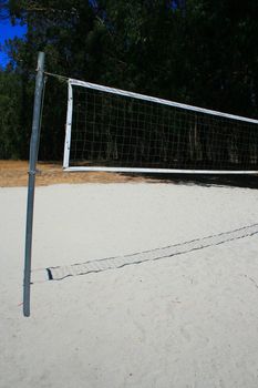 Beach volleyball net over bright blue sky.
