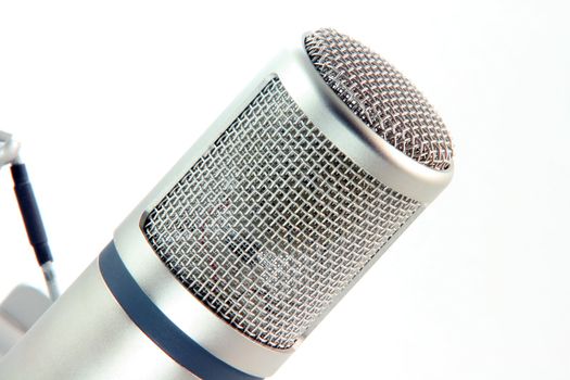 detail from microphone head isolated on white music concepts