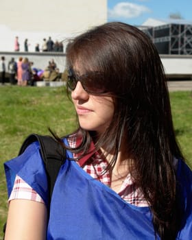 The young beautiful woman in city street