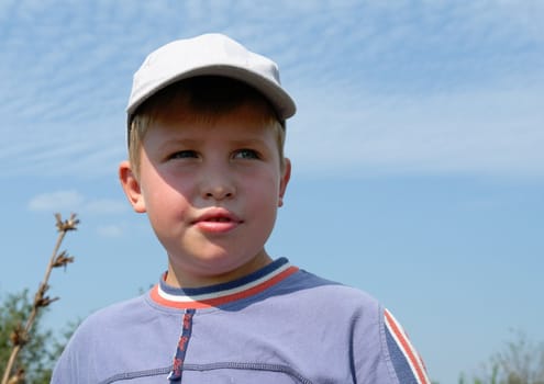 little boy with blue sky at background
