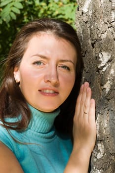 Portrait. The beautiful young woman near a birch.