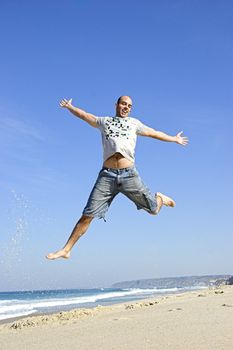 Man jumping on the beach and having fun