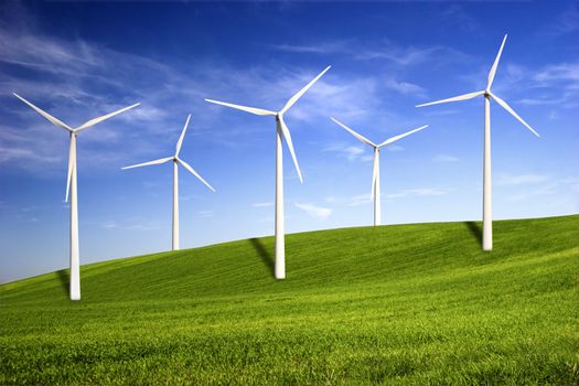 Beautiful green meadow with Wind turbines generating electricity