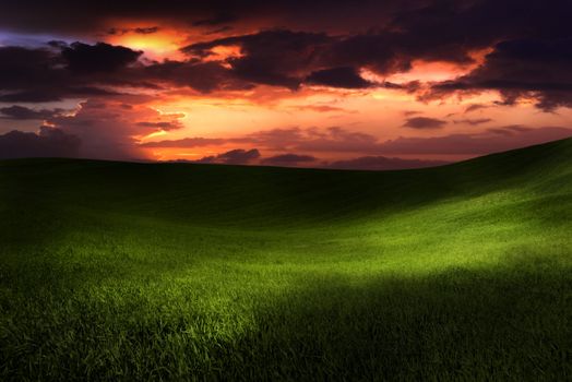 Beautiful green meadow with sunset clouds