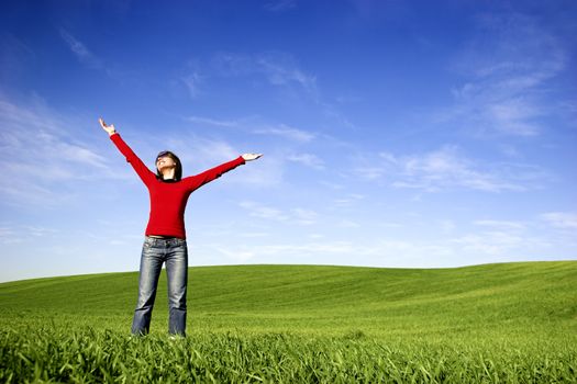 Young woman relaxing on a beautiful green meadow 